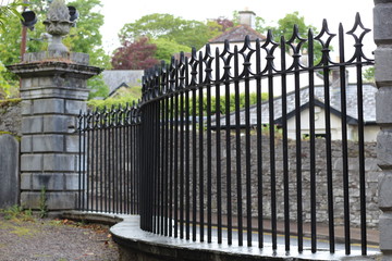 Black metal fence stone pillars