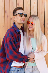 Loving couple posing against fence