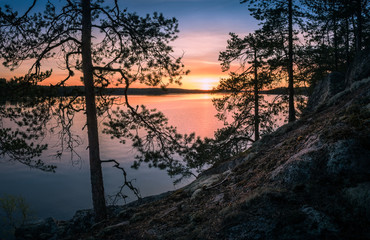 Scenic landscape over lake with sunset at spring evening in Finland