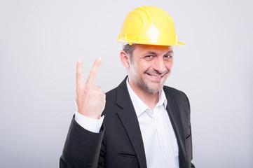 Portrait of handsome engineer showing number two gesture