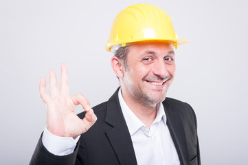 Contractor wearing hardhat making ok gesture