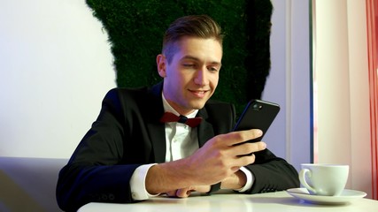 Close up of a young man using a smartphone
