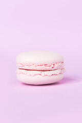 One sweet purple macaroon on purple table background.