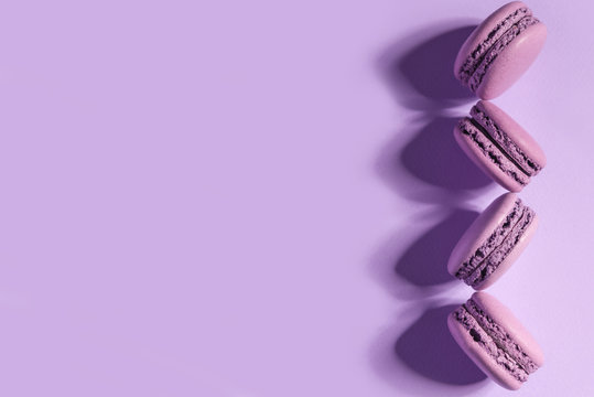 Sweet Purple Macaroons On Purple Table Background.