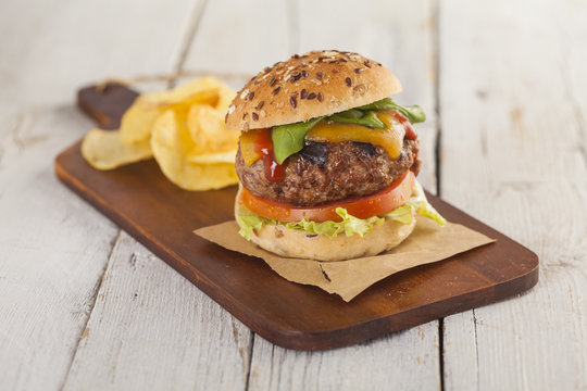 Delicious burger with beef, tomato, cheese and lettuce 