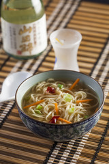 Asian soup with noodles in a decorated bowl