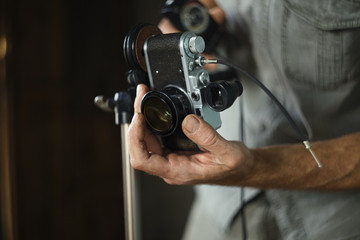 Vintage retro camera in the hands of the old  photographer.