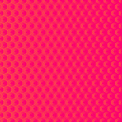 An abstract geometric background or pattern that is made up of hexagons of different sizes. Modern texture in pink and orange