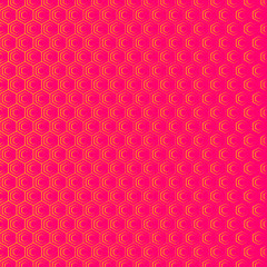 An abstract geometric background or pattern that is made up of hexagons of different sizes. Modern texture in pink and orange