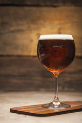 Glasses of beer on a wooden background