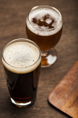 Glasses of beer on a wooden background