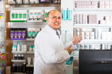 Naklejka na ściany i meble Male pharmacist in drugstore.