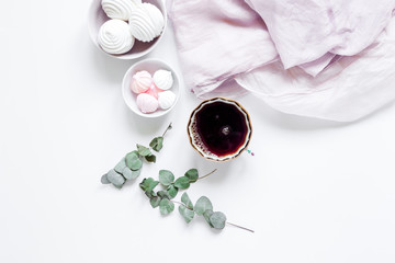 woman lunch with marsh-mallow, coffee and flowers soft light on white table background flat lay