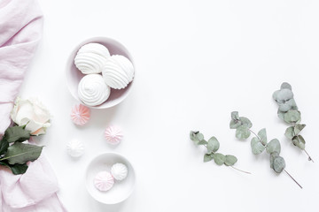 woman lunch with marsh-mallow and flowers soft light on white table background flat lay mockup