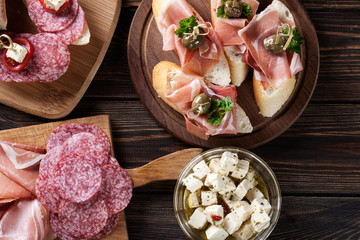 Spanish tapas with slices jamon serrano, salami, olives and chee