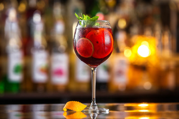 Closeup glass of red wine  fresh sangria at bright bar counter background. - obrazy, fototapety, plakaty