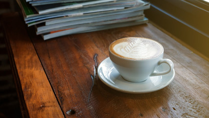 A cup of coffee was put in a stack of a book.