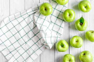 fitness food with green apples and napkin on white background top view