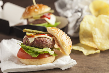     Deluxe gourmet burger on wooden table 