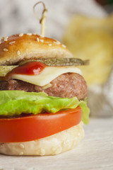     Deluxe gourmet burger on wooden table 