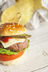     Deluxe gourmet burger on wooden table 