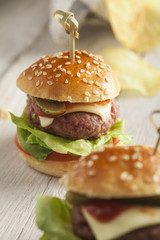     Deluxe gourmet burger on wooden table 