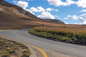 Asphalt Road Running Through Dry Orange Winter Mountain Landscape