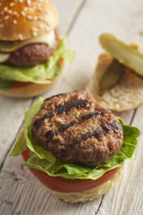     Deluxe gourmet burger on wooden table 