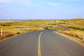 asphalt road on grassland