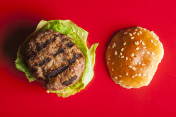 Deluxe gourmet burger on red table 