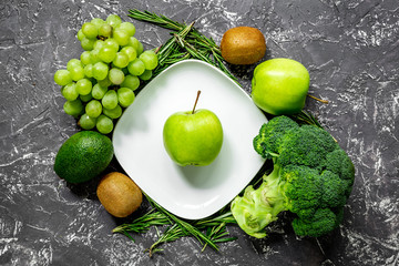 healthy green food with fresh vegetables on dark table background top view