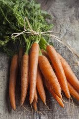 Bunch of carrot on a wooden background