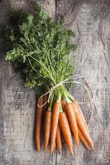 Bunch of carrot on a wooden background