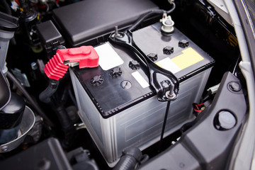 Battery installed near the V8 motor in SUV - obrazy, fototapety, plakaty