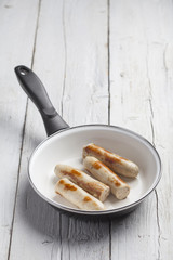 Sausages on a frying pan