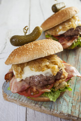     Deluxe gourmet burger on wooden table 