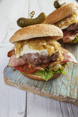     Deluxe gourmet burger on wooden table 