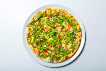 Pizza with seafood and arugula isolated on white