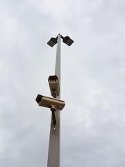 Security CCTV camera in cloudy sky at a gas station in Thailand