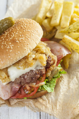    Deluxe gourmet burger on wooden table 