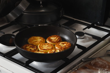 Cheese pancakes in frying pan