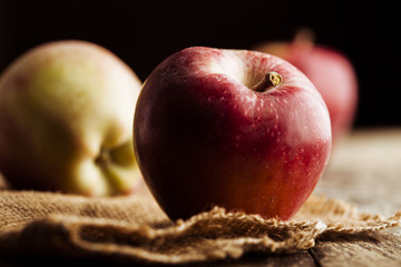 Red apples on wooden background