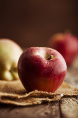 Red apples on wooden background