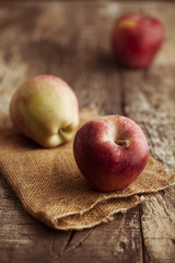 Red apples on wooden background