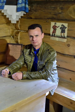 The tourist in the interior of an old Russian log hut in Pushkin