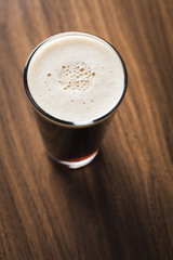 Glass of beer on wooden background
