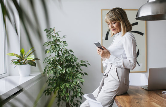 Businesswoman using smartphone in conference room