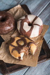 Chocolate donuts on a blue wooden table