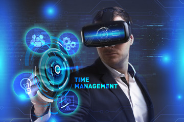 Business, Technology, Internet and network concept. Young businessman working in virtual reality glasses sees the inscription: Time management