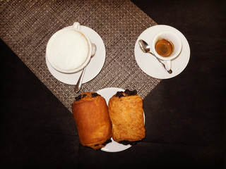 Italian breakfast with coffee, cappuccino and two chocolate briochees